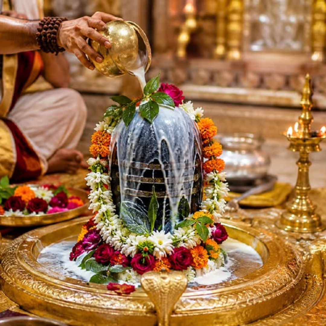 Priest performing milk abhishek on a Shivling during Rudrabhishek puja
